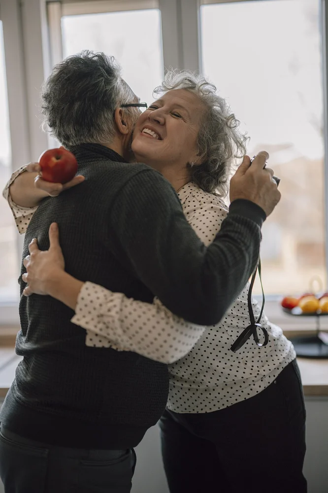 happy facial expression photo — Couple enjoys a happy moment together in a bright kitchen