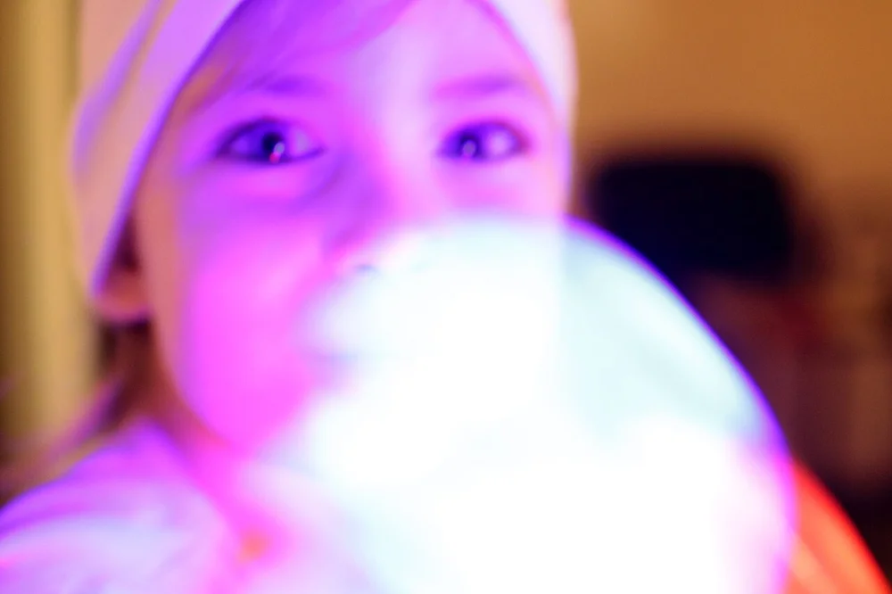 surprised facial expression photo — Five year old girl in a state of excitement and agitation, listening to trance m